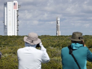 caption: Photographers capture the Boeing Starliner capsule atop an Atlas V rocket as it is rolled out to the launch pad at Space Launch Complex 41, Saturday, May 4, 2024, in Cape Canaveral, Fla.