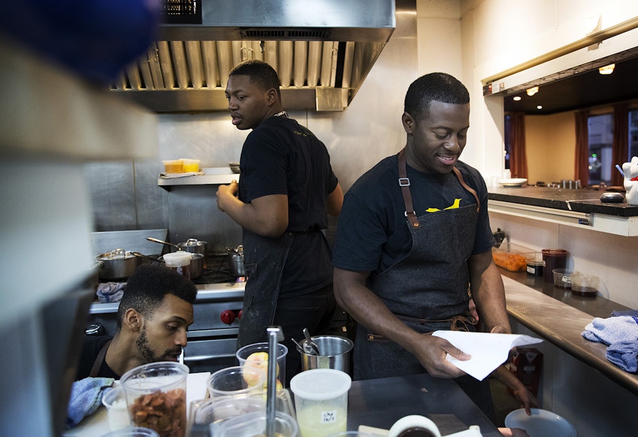 caption: Edouardo Jordan, right, works in the kitchen at JuneBaby on Wednesday December 6, 2017, in Seattle. 