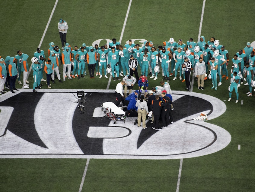 caption: Teammates gather around Miami Dolphins quarterback Tua Tagovailoa (1) after an injury during the first half of an NFL football game against the Cincinnati Bengals, Thursday, Sept. 29, 2022, in Cincinnati.