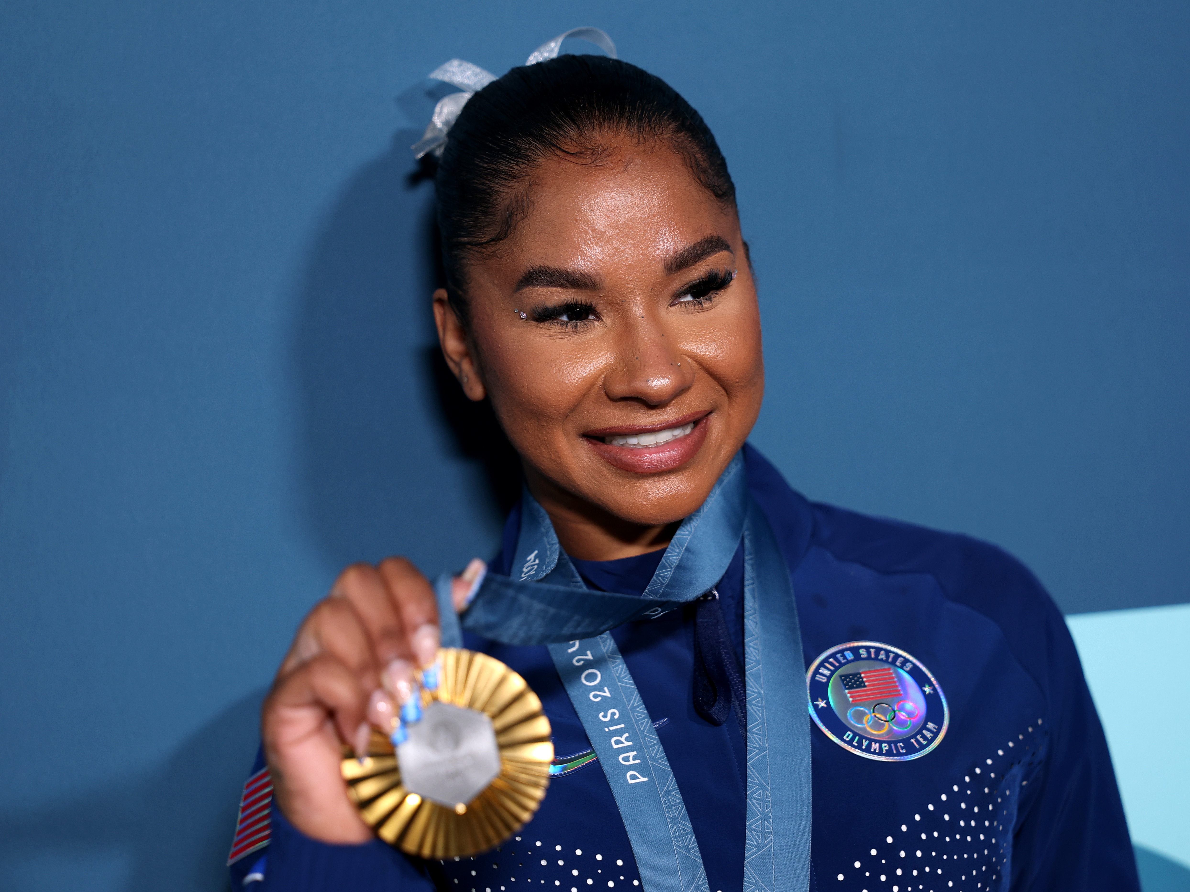 caption: Jordan Chiles of the United States, poses with her bronze medal following the women's gymnastics floor exercise event final on Monday at the Paris Olympics. The International Olympic Committee says Chiles must return the medal following an arbitrator's decision that her initial scoring appeal came in four seconds too late.