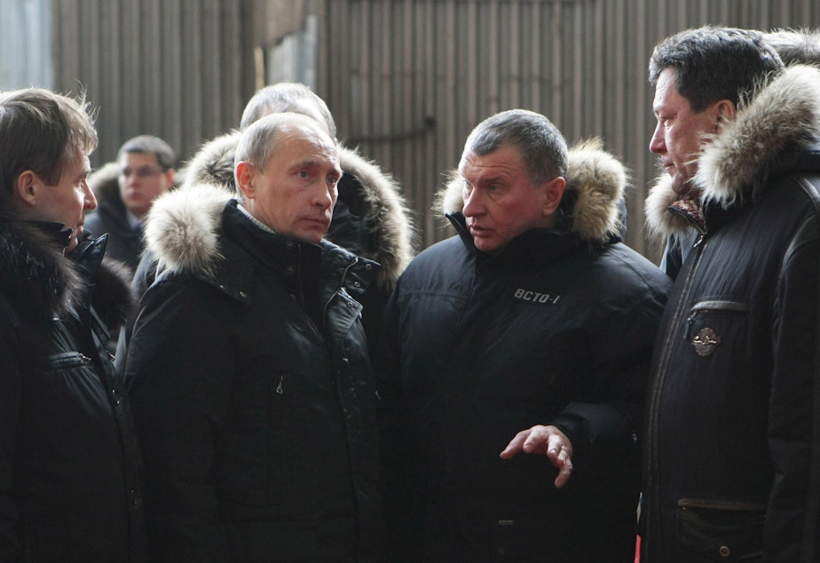 caption: Vladimir Putin speaks with Russian oligarch Igor Sechin (center right) in 2009.