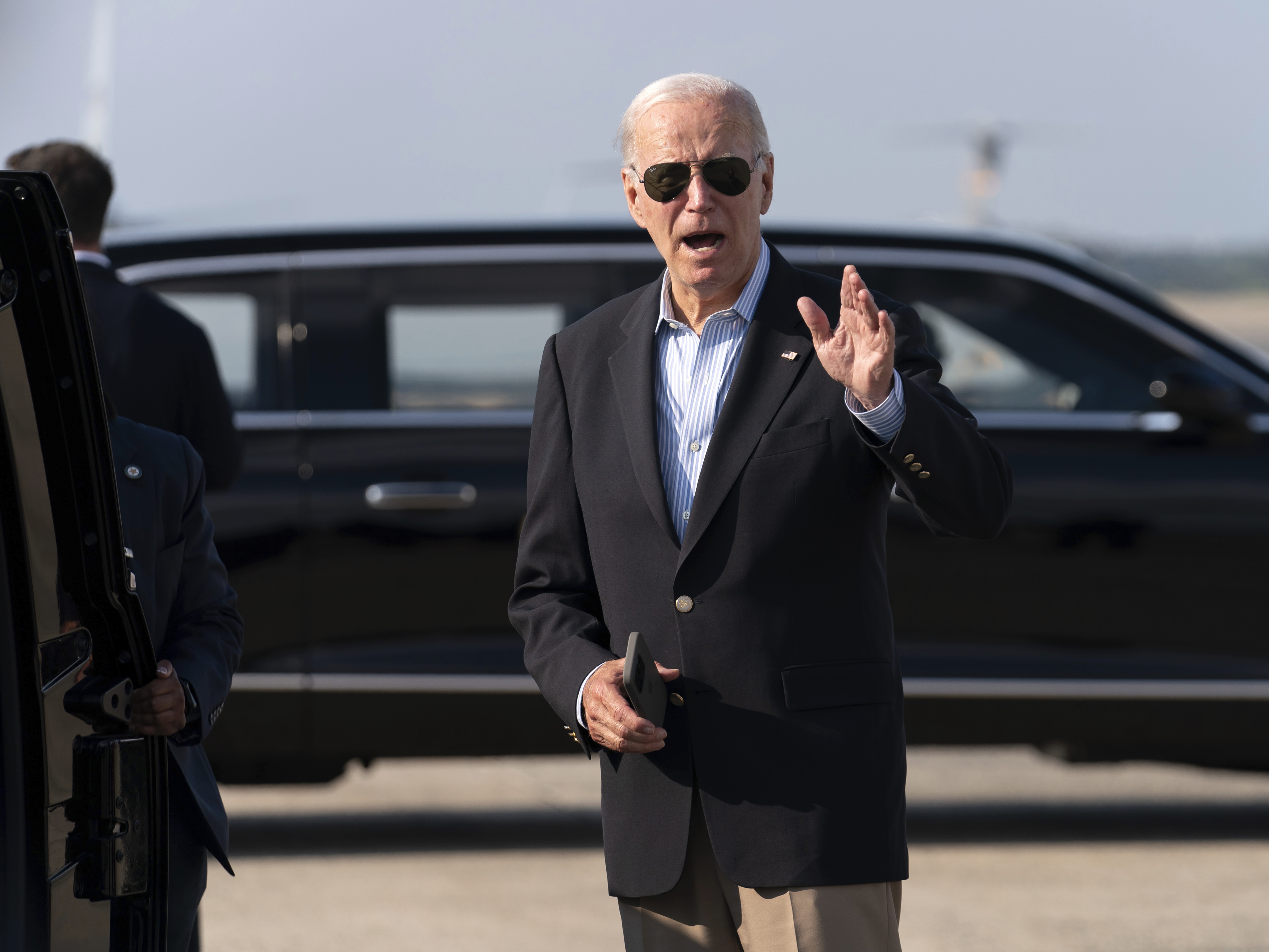 caption: President Joe Biden talks to reporters upon his arrival to Joint Base Andrews, Md., en route to the White House on Sunday.