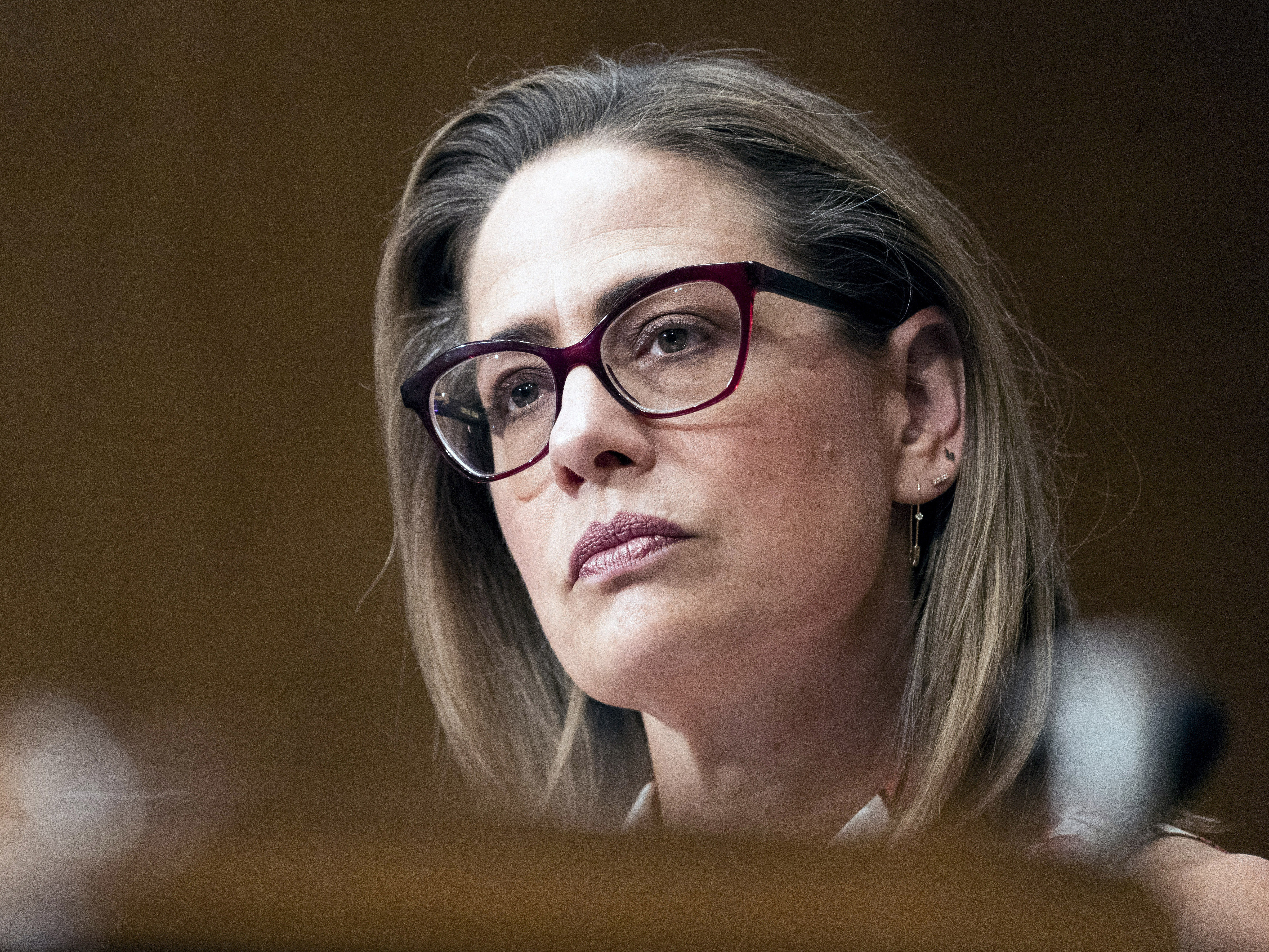 caption: Sen. Kyrsten Sinema, D-Ariz., speaks during a Senate Homeland Security and Governmental Affairs committee hearing to examine social media's impact on homeland security, Sept. 14, 2022, on Capitol Hill in Washington.