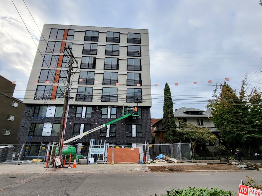 caption: The apartment building next to the Garber house is nearly completed and ready for residents on Wednesday, September 22, 2021.