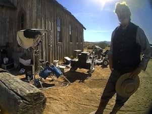 caption: Alec Baldwin, seen here talking to police after a fatal shooting on the <em>Rust</em> movie set in 2021, faces a felony criminal trial in New Mexico this summer. This image is from video released by the Santa Fe County Sheriff's Office.