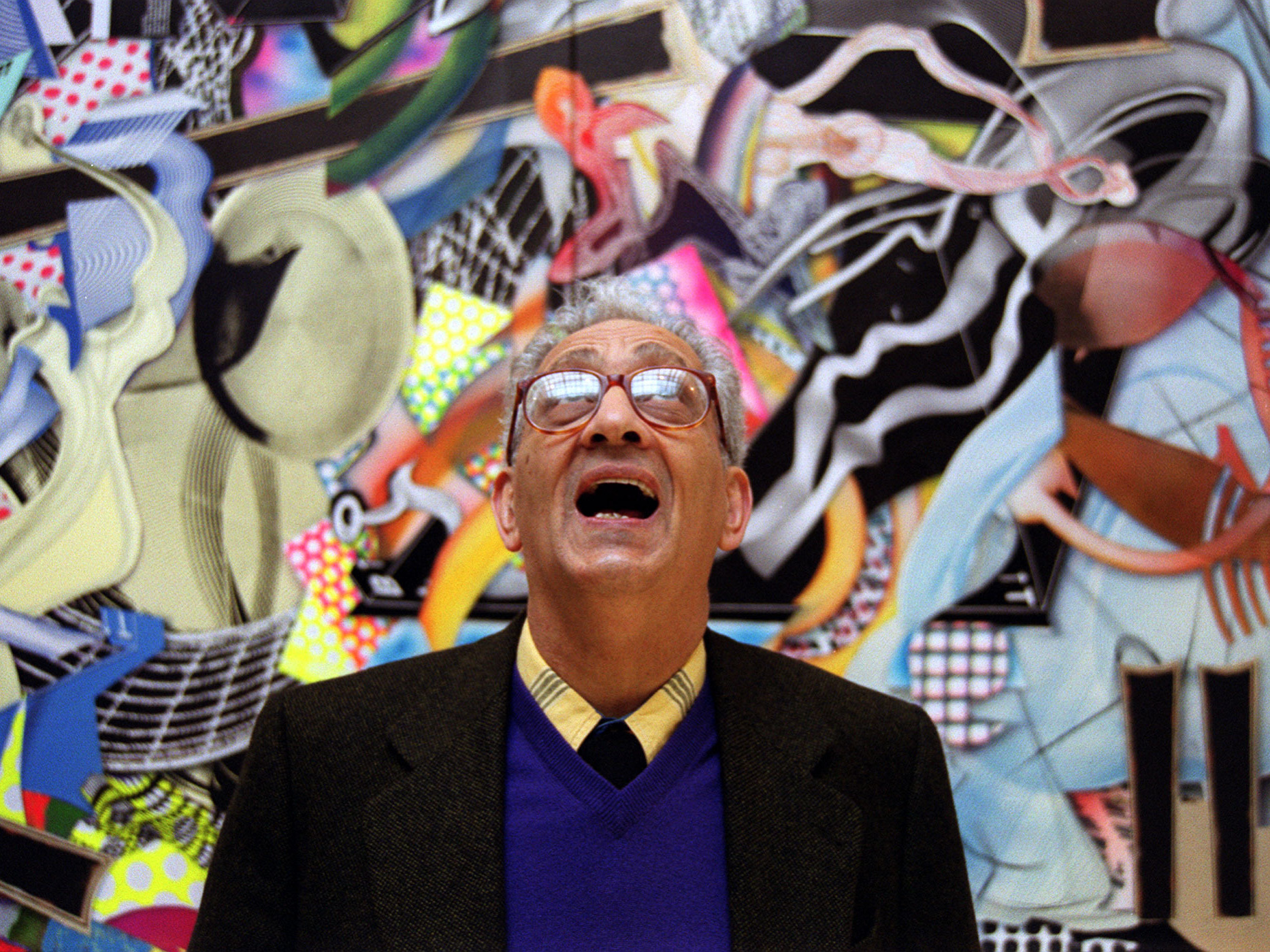 caption: Frank Stella with one of his works at the Royal Academy's Summer Exhibition in London in 2000.