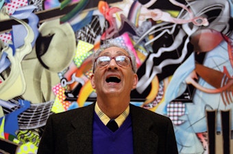 caption: Frank Stella with one of his works at the Royal Academy's Summer Exhibition in London in 2000.