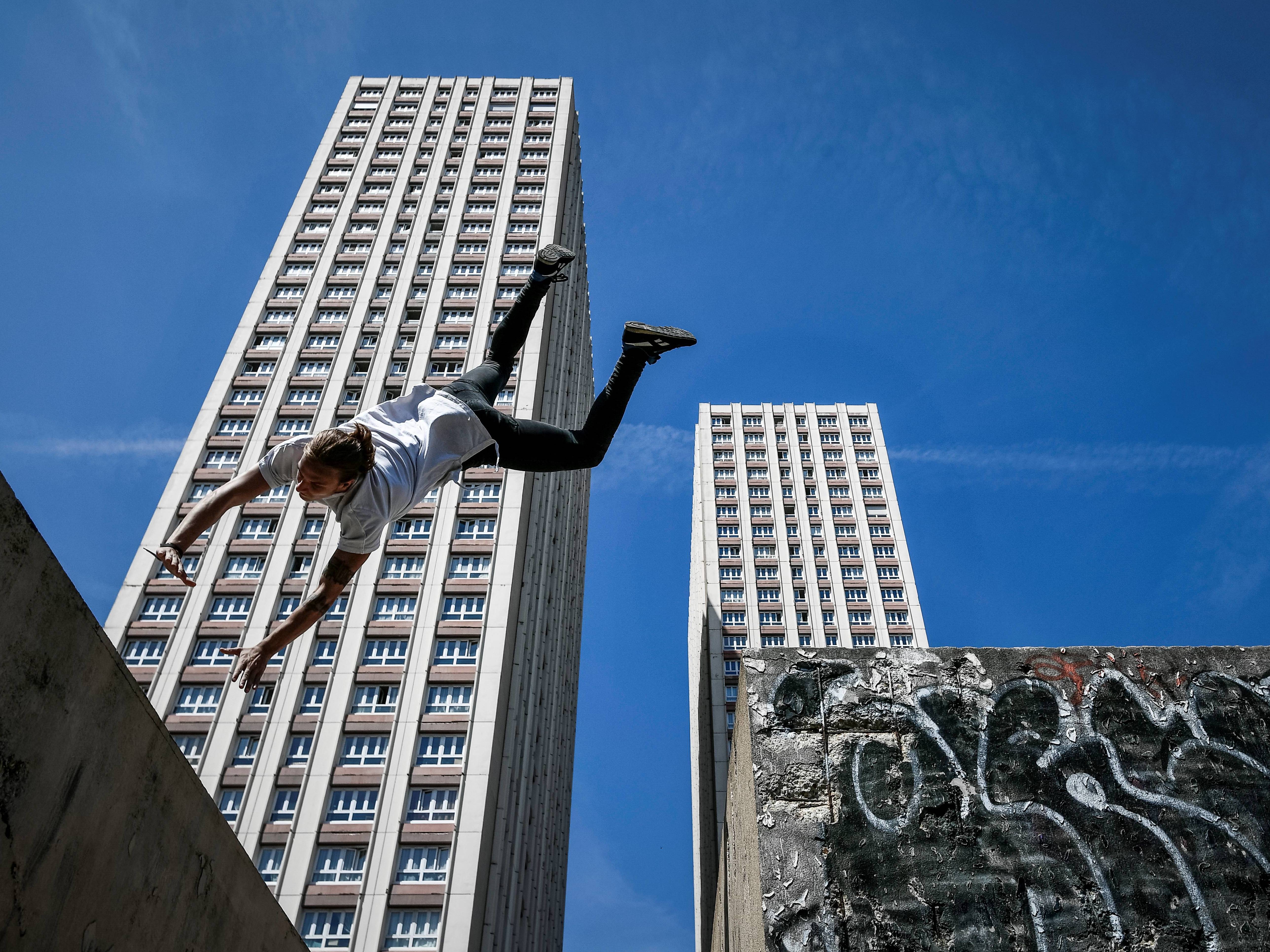 caption: Many in the parkour community are resisting attempts by the International Gymnastics Federation to bring the sport under its umbrella. Here, Johan Tonnoir practices parkour in Paris in May.
