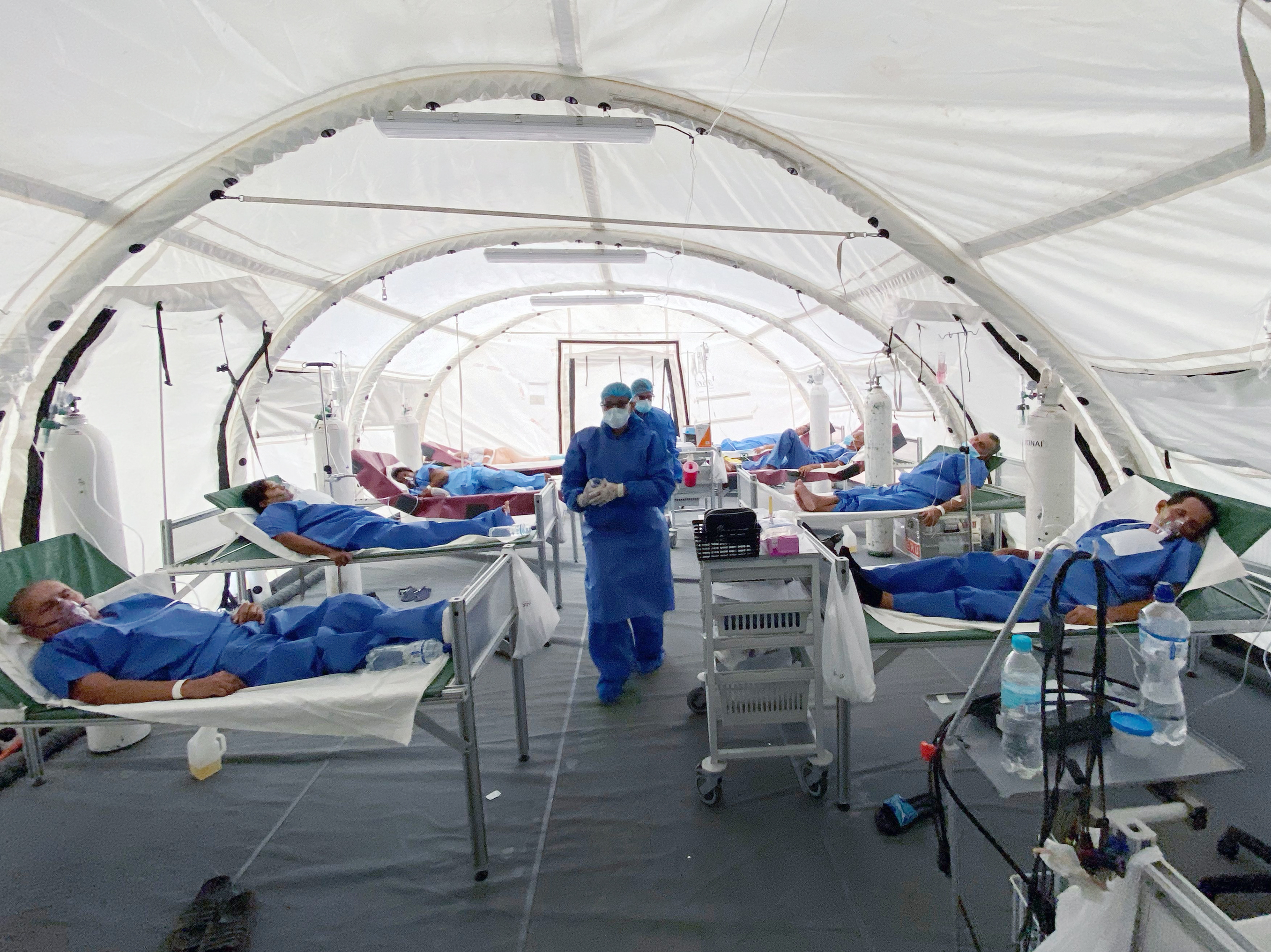 caption: Patients are treated for COVID-19 at a field hospital in Guayaquil, Ecuador.