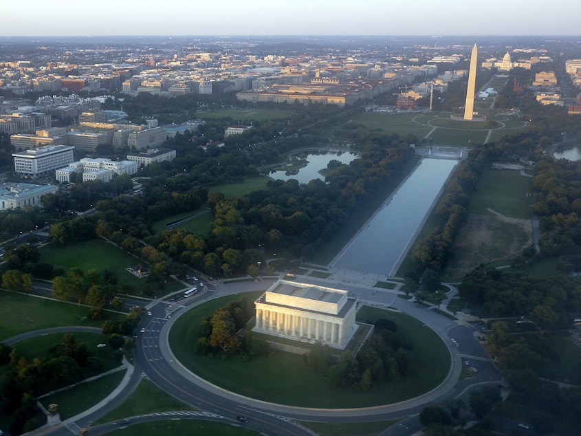 caption: The skyline of Washington, D.C., including the Lincoln Memorial, Washington Monument, U.S. Capitol and National Mall, seen on June 15, 2014.
