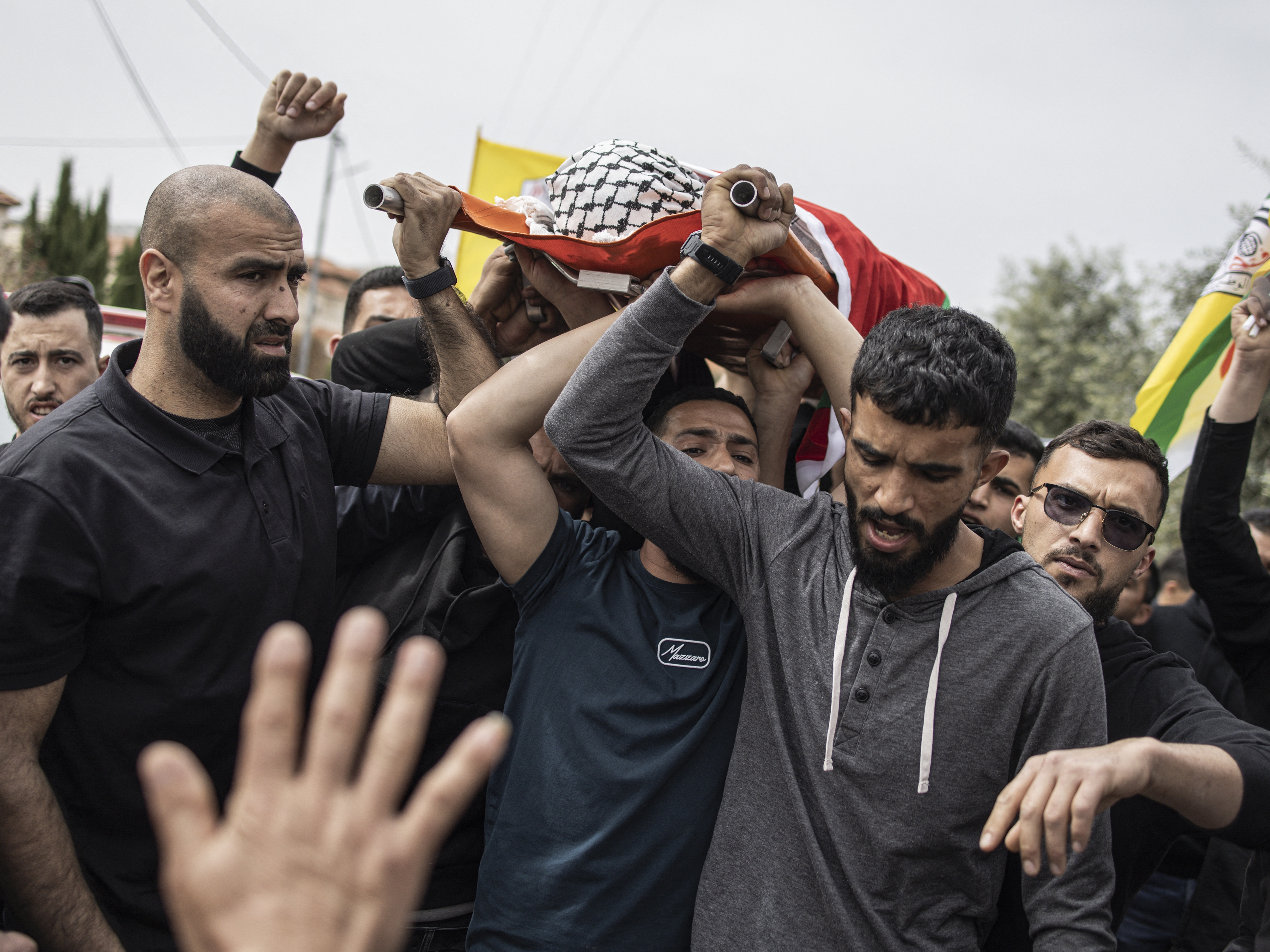 caption: Mourners carry the body of 14-year-old Palestinian Amir Rabee, a U.S. citizen, during his funeral in the village of Turmus Ayya, in the Israeli-occupied West Bank, on Monday.
