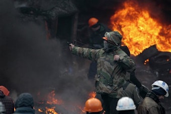caption: Protests in Ukraine have led to the resignation of the prime minister and the deaths of at least five people.