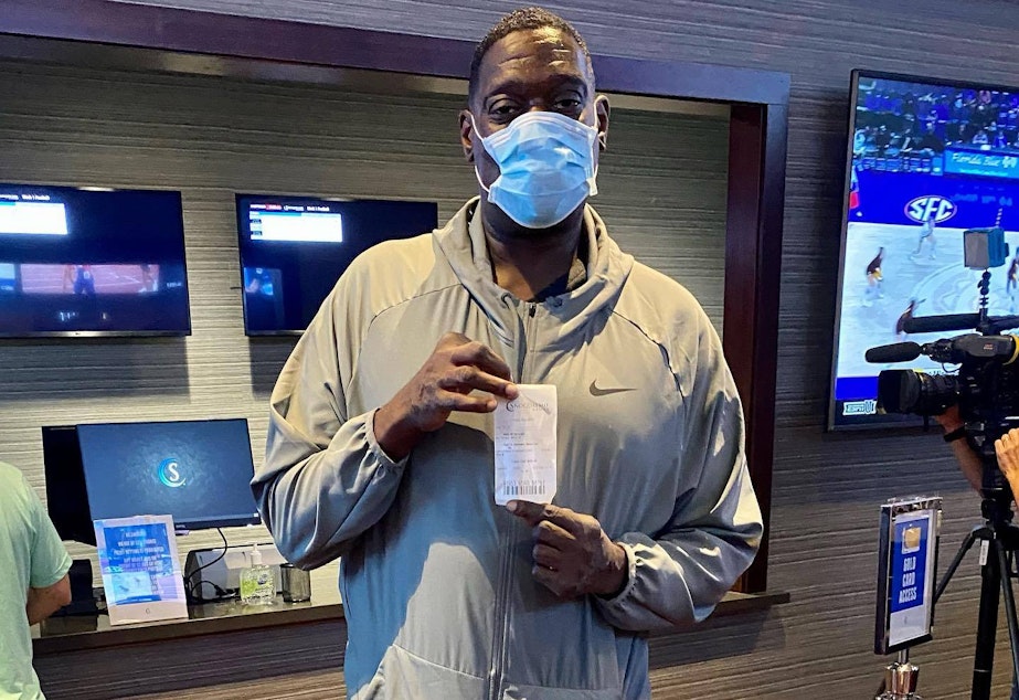 caption: Seattle SuperSonics legend Shawn Kemp placed the first legal sports bet in Washington at the Snoqualmie Casino on Thursday.