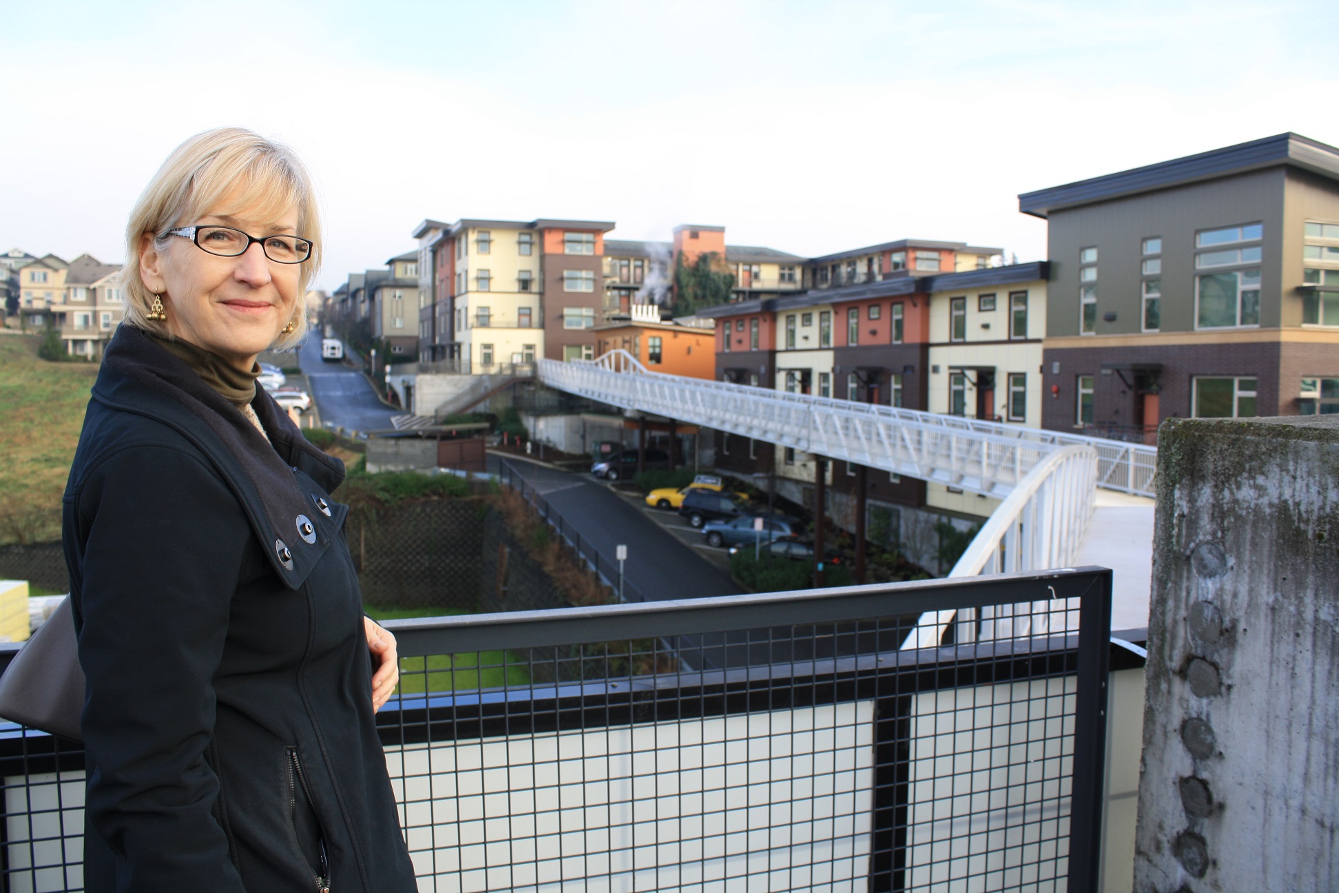 caption: Issaquah head planner Lucy Sloman stands at the rail of the Issaquah Highlands park and ride.