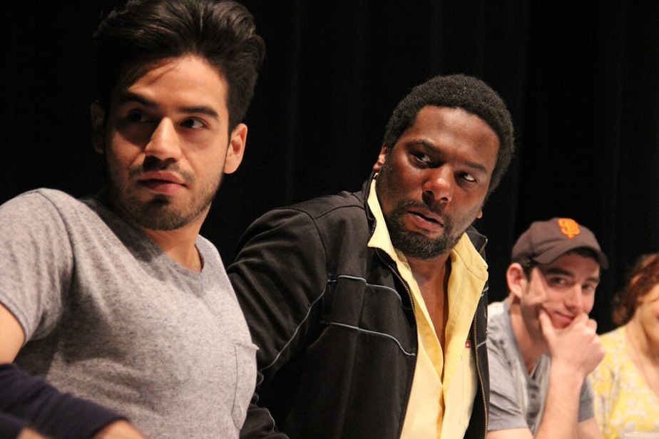 caption: Moises Castro, Reginald André Jackson, and Riley Shanahan in an Intiman workshop of 'John Baxter Is a Switch Hitter' at the Intiman.