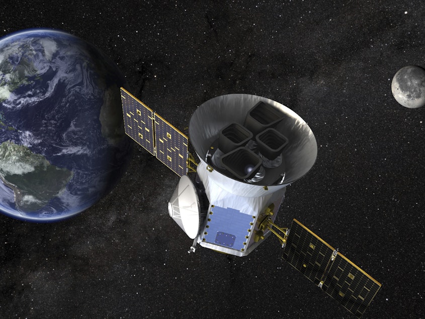 caption: This image made available by NASA shows an illustration of the Transiting Exoplanet Survey Satellite (TESS).