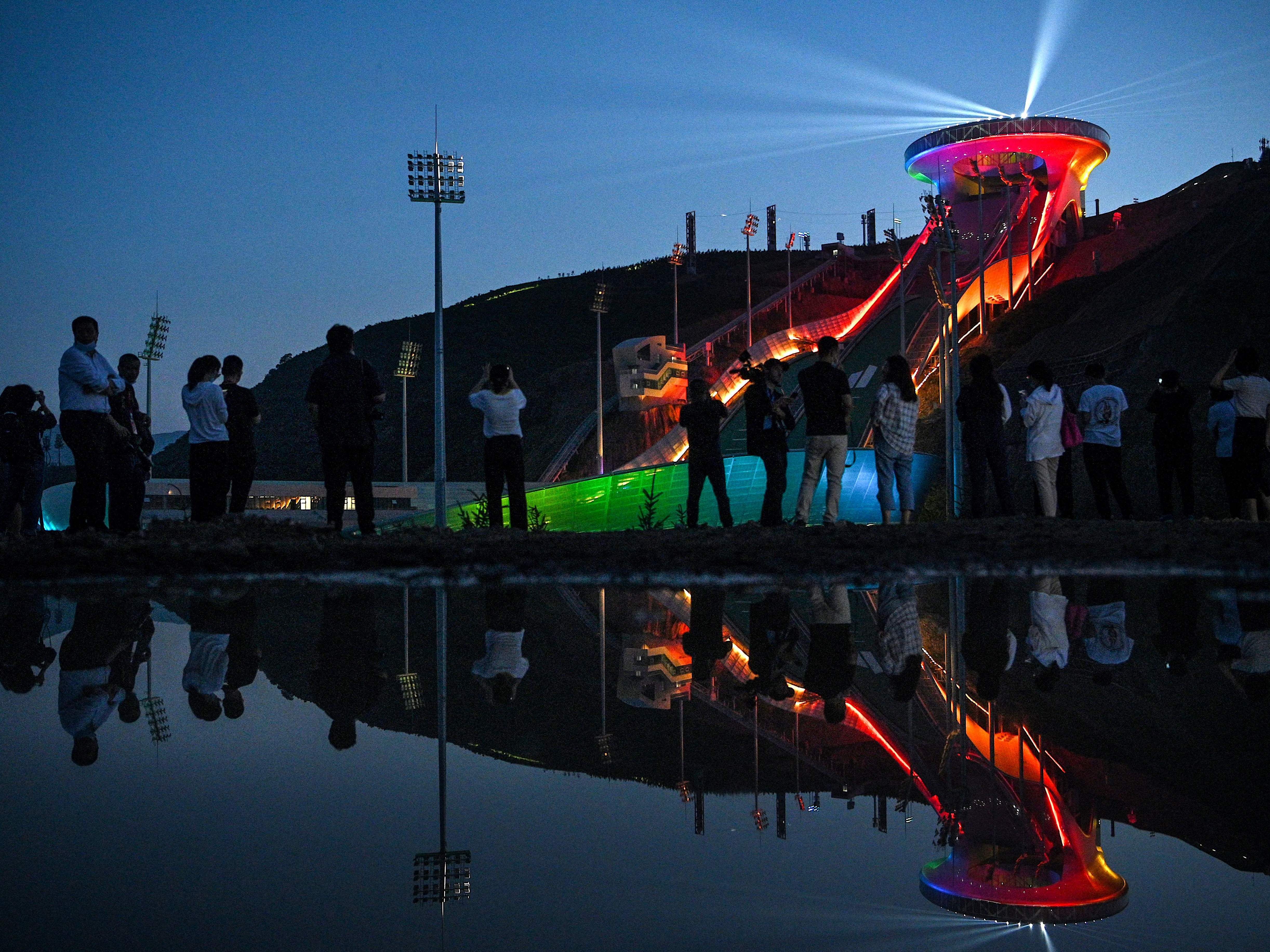 caption: The Beijing Winter Olympics are set to open in February. Visitors recently watched a light show at the newly built ski jumping center in northern China's Hebei province.
