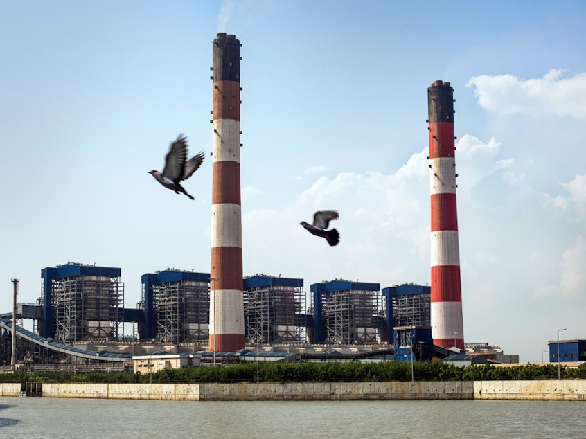 caption: The coal-fired Tata Mundra power plant in western India was funded by a branch of the World Bank. A group of farmers and fishermen are suing, claiming that contamination of local water sources has disrupted their livelihoods.