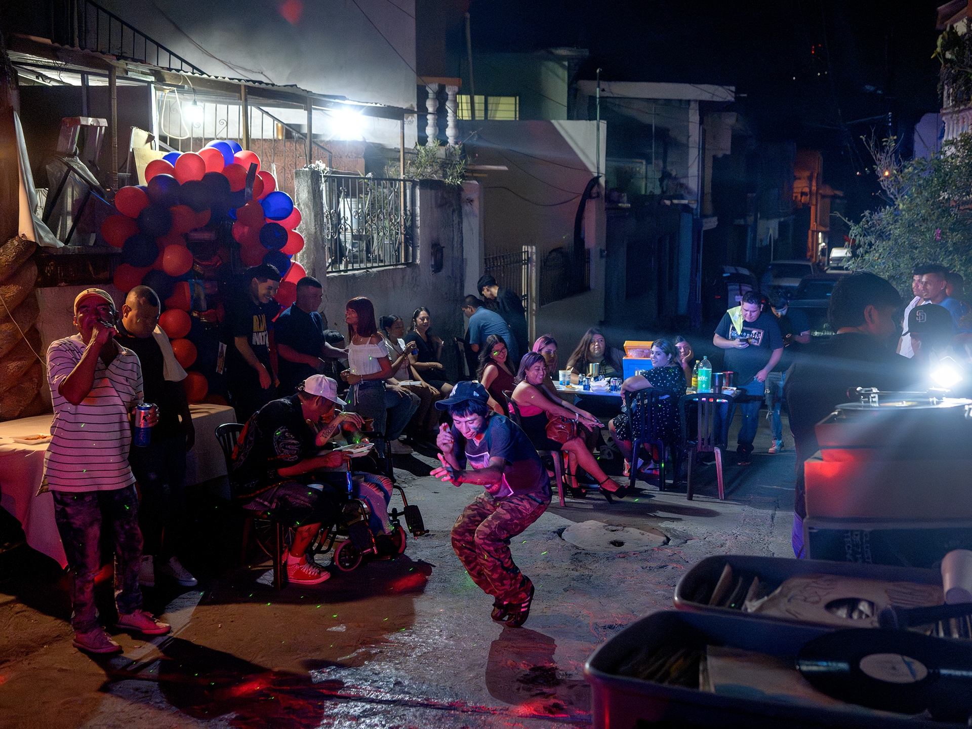 caption: People dance at Brenda Cazárez's 40th birthday party as Sonido Colombia plays music in the Privada Cusco neighborhood of Monterrey, Mexico, on Aug. 12, 2023.