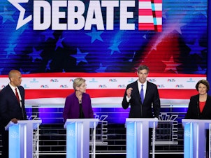 caption: Former Texas Rep. Beto O'Rourke (third from left) speaks as Sens. Cory Booker, Elizabeth Warren and Amy Klobuchar look on during the first night of the Democratic presidential debate, Wednesday in Miami.