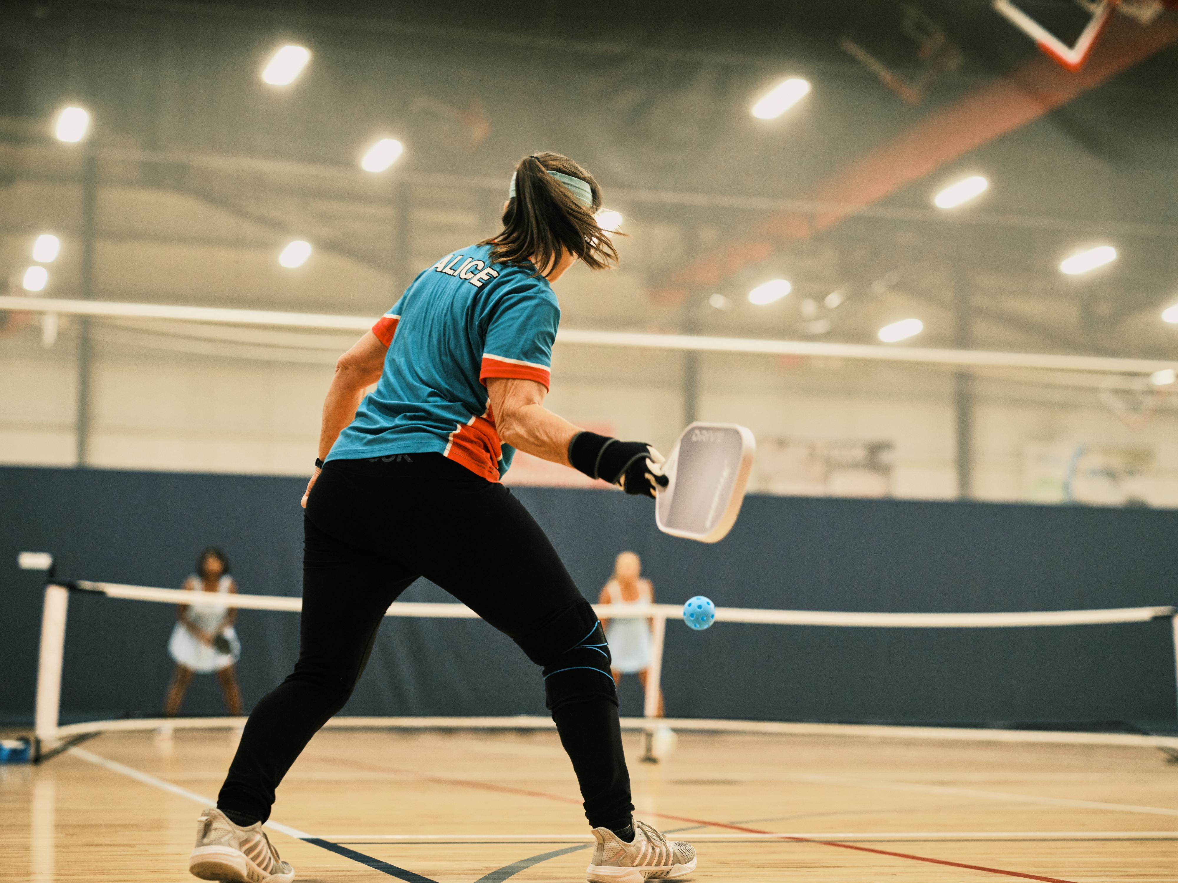 caption: Pickleball player Alice Edington, 56, returns the ball to her opponents during a doubles match at the Florida Senior Games. Pickleball is the fastest-growing sport and it's also popular with older athletes.