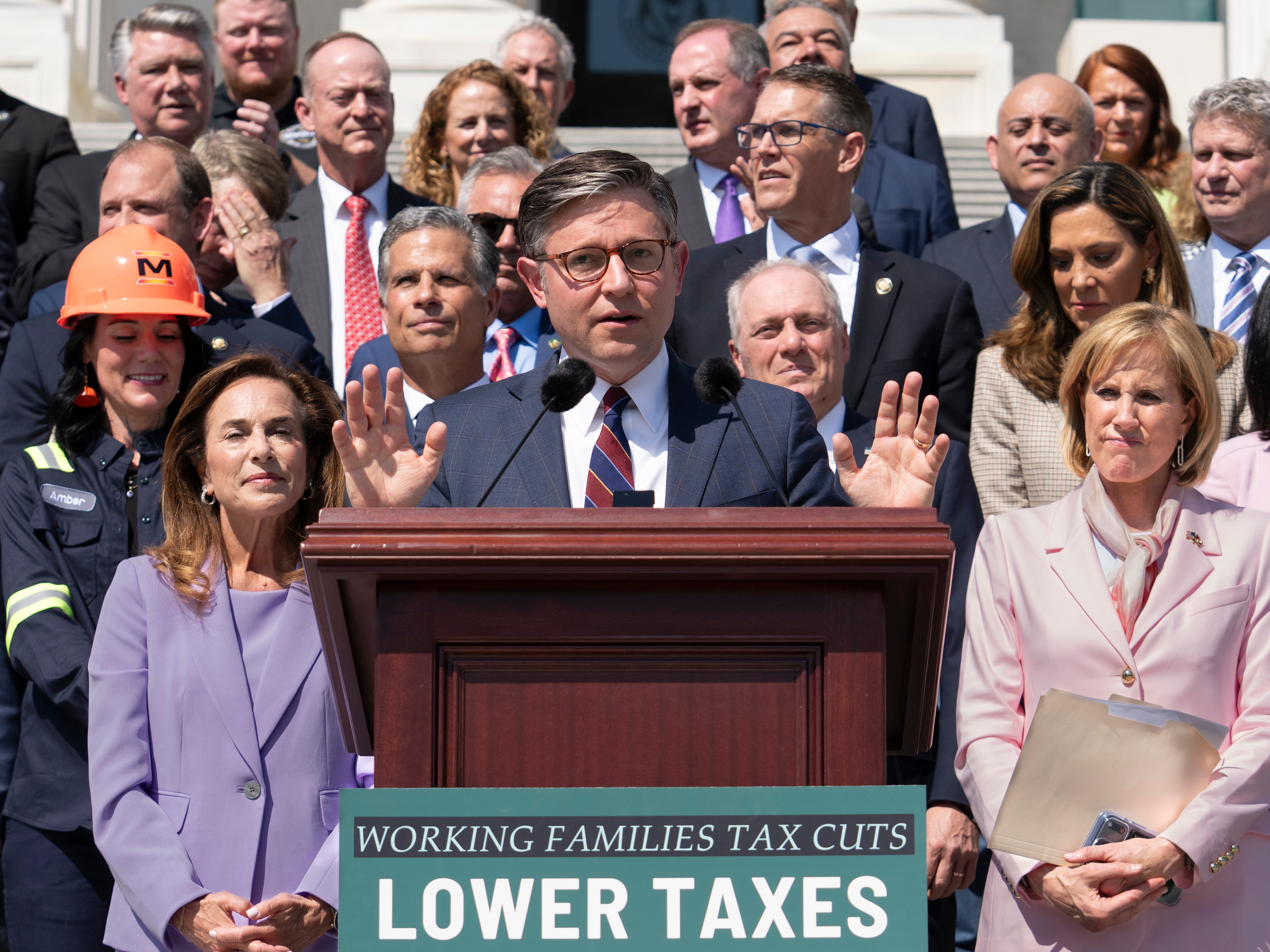 caption: Speaker of the House Mike Johnson, R-La., and fellow Republicans celebrate GOP tax policies at an event outside the Capitol in Washington, Wednesday, April 15, 2026.
