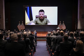 caption: Ukrainian President Volodymyr Zelenskyy delivers a virtual address to Congress at the U.S. Capitol on March 16, 2022, less than a month after Russia's invasion of Ukraine.