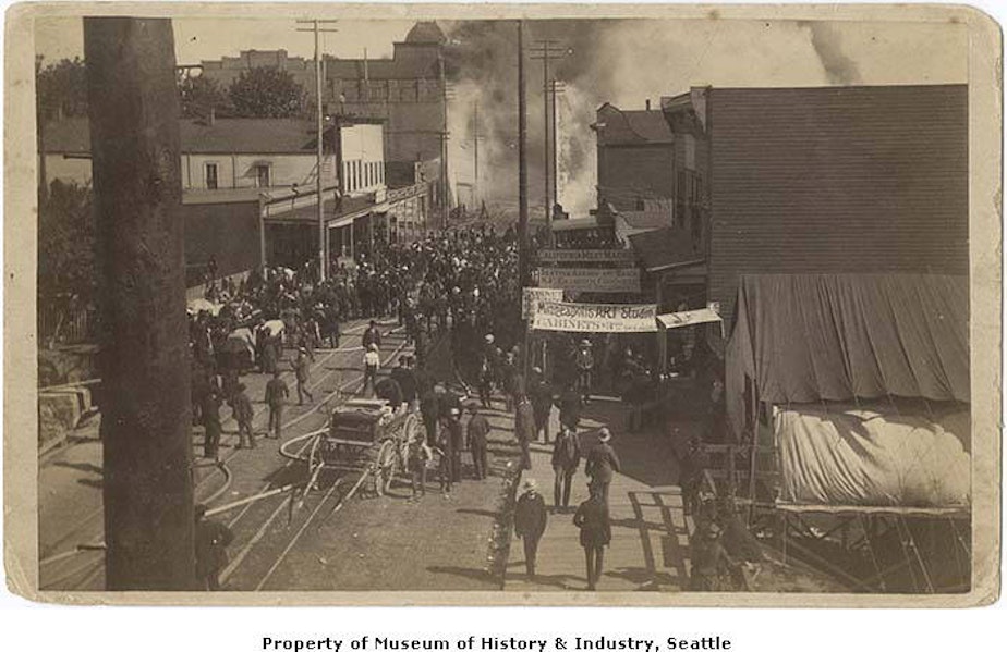 caption: In this image crowds gather to watch the fire on Front Street (later First Avenue) at Union Street on June 6, 1889.