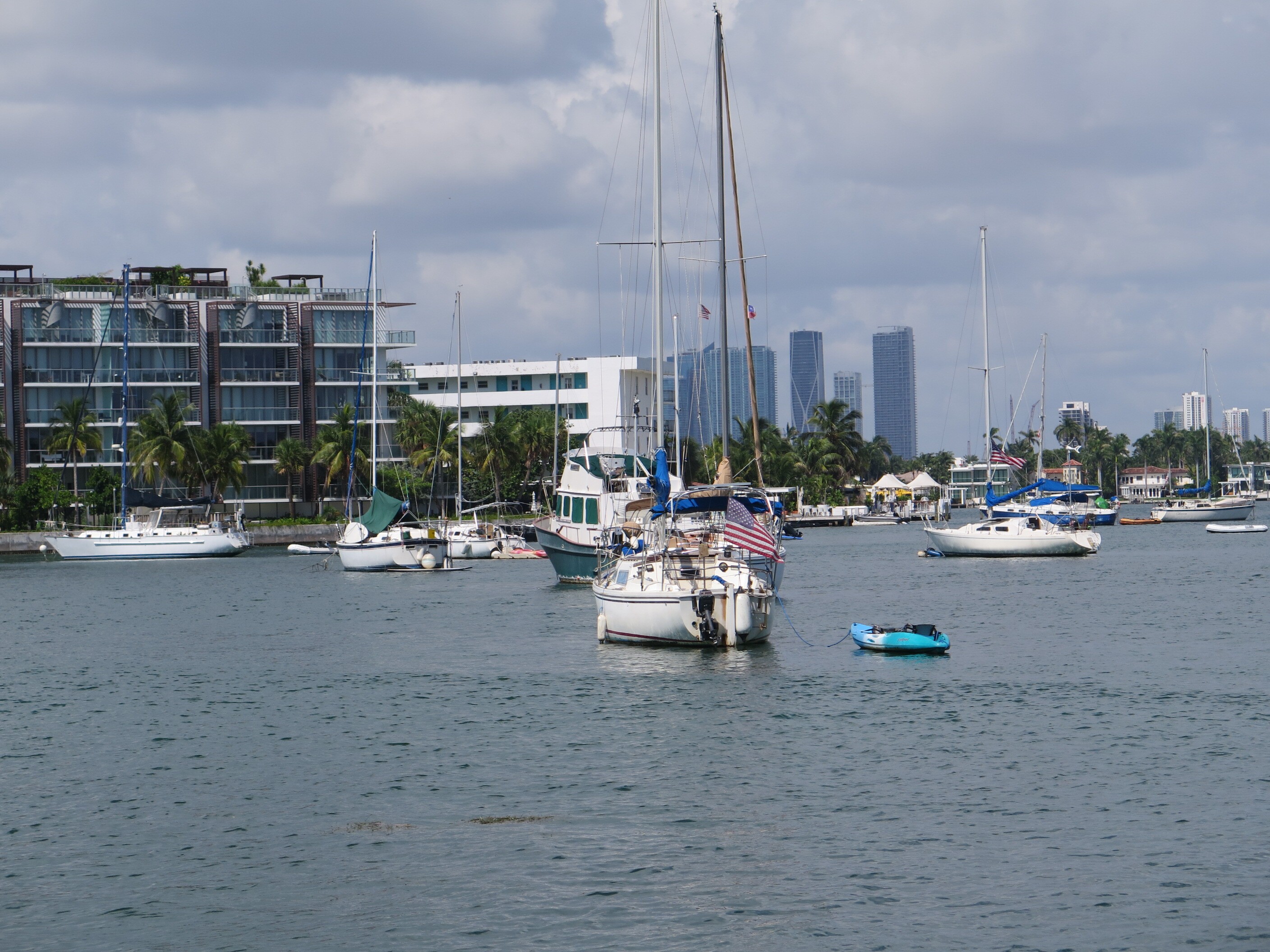 caption: More than 100 people live aboard sailboats and other vessels anchored just off Miami Beach. For years, some in the posh seaside community have not been happy about people just offshore.