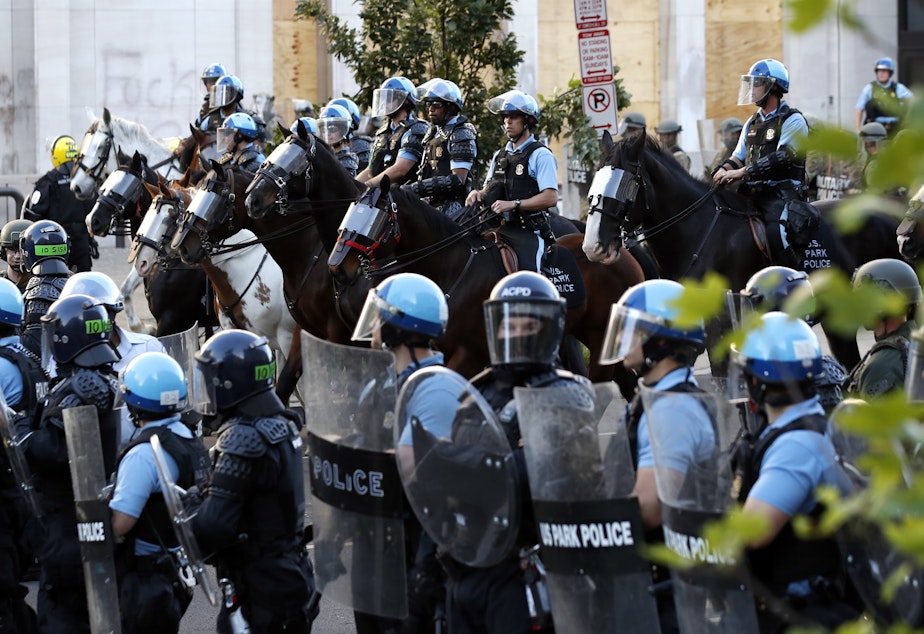 caption: Police gather to remove demonstrators from the area around Lafayette Park and the White House before President Trump's walk to St. John's Church.