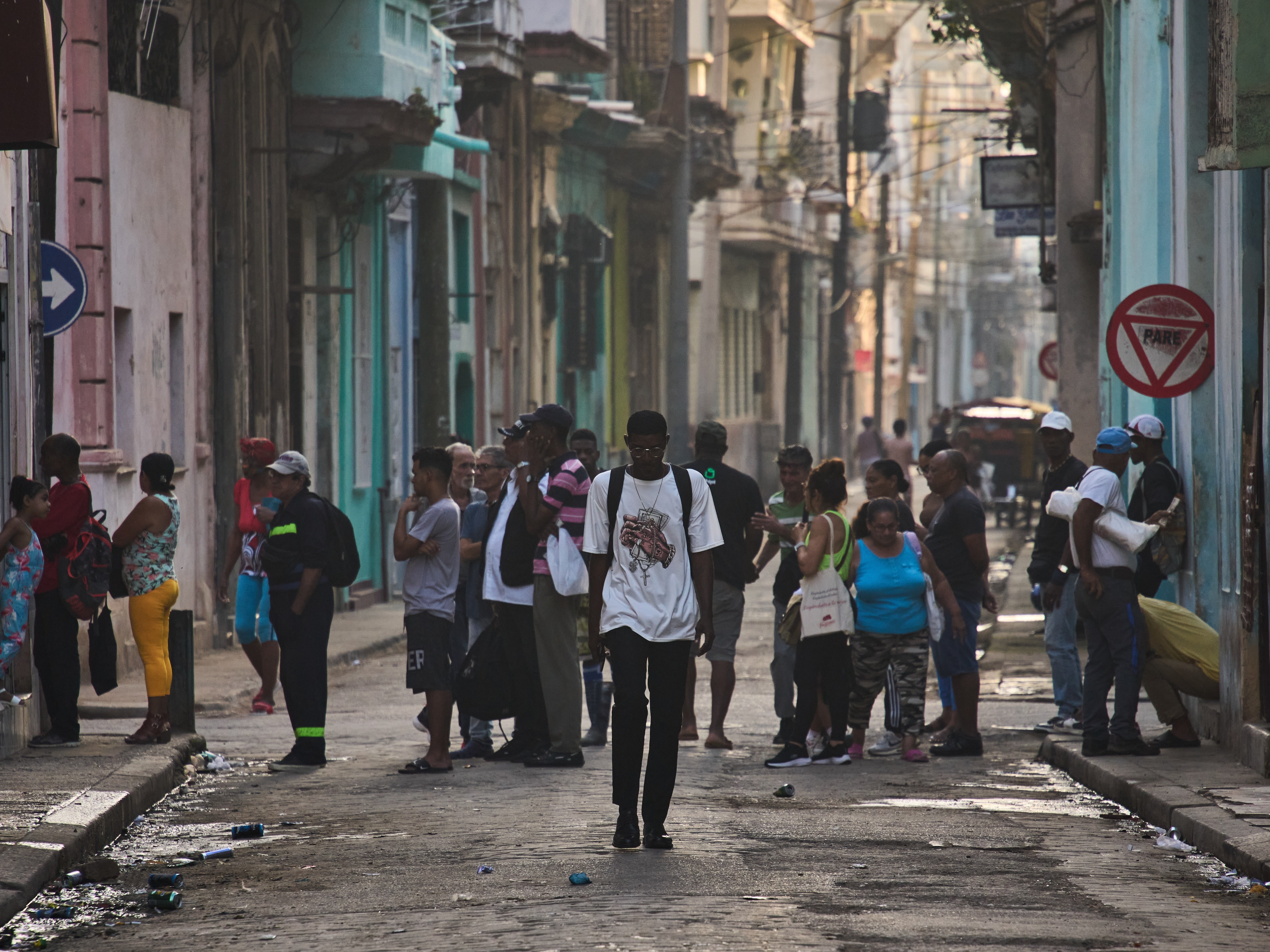 caption: People line up in the street to buy bread in Havana, Cuba, Friday, March 13, 2026.