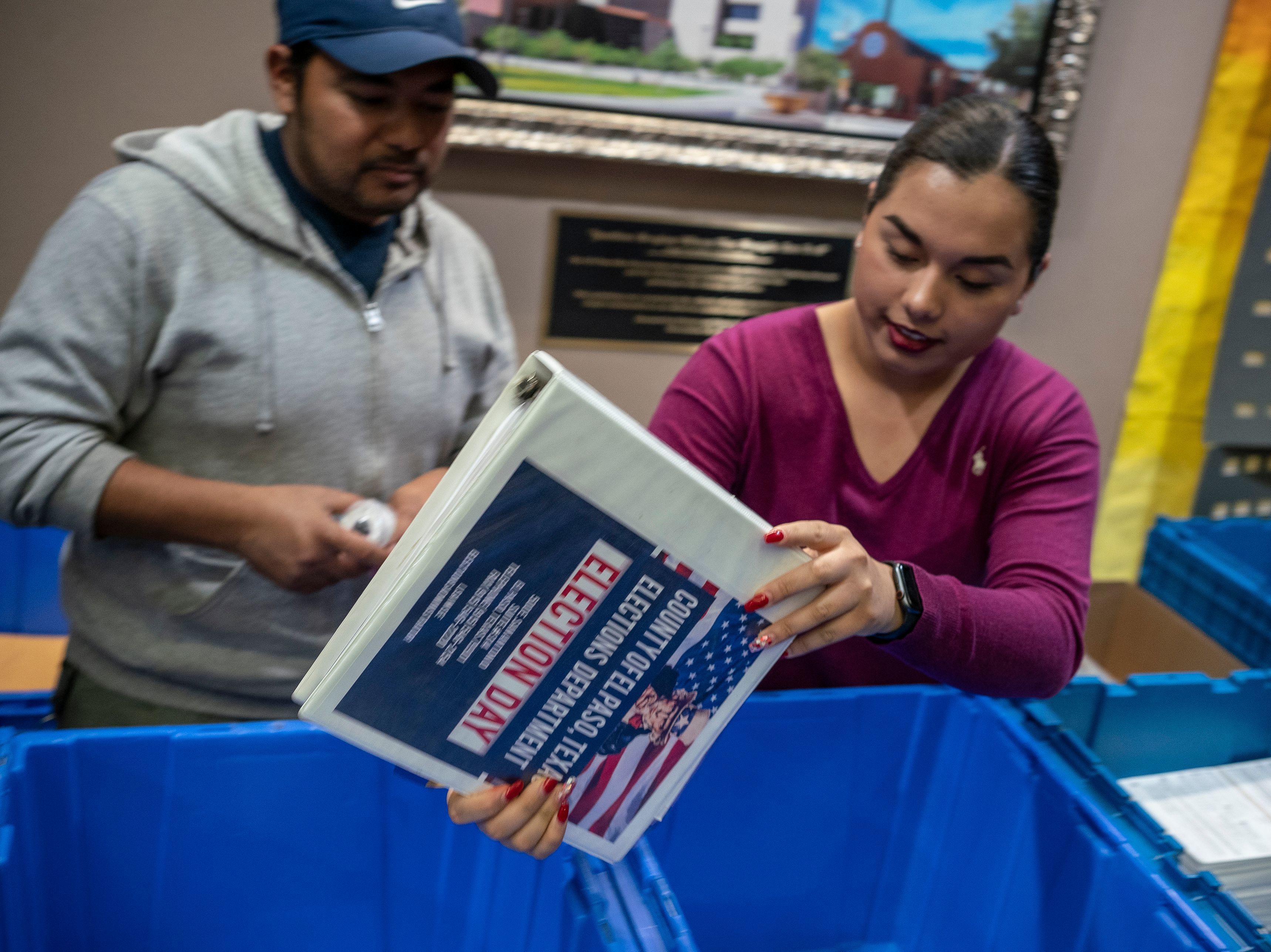 caption: Jonathan Lucero and Valeria Gutierrez prepare to receive ballots at the El Paso County Courthouse during the presidential primary in March.