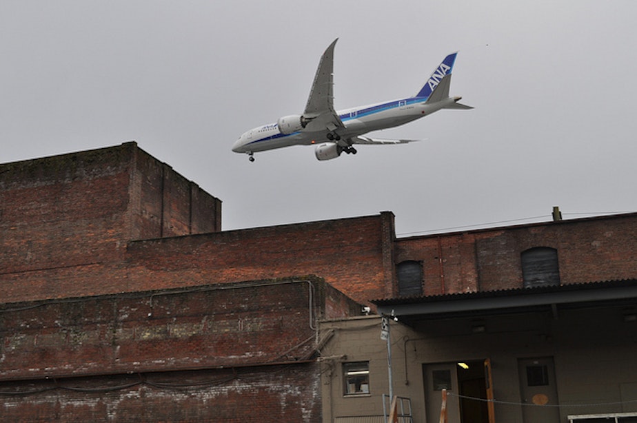 caption: A low flying plane passes over Georgetown. Noise and local industrial pollution can sometimes give the area a bad rap. 