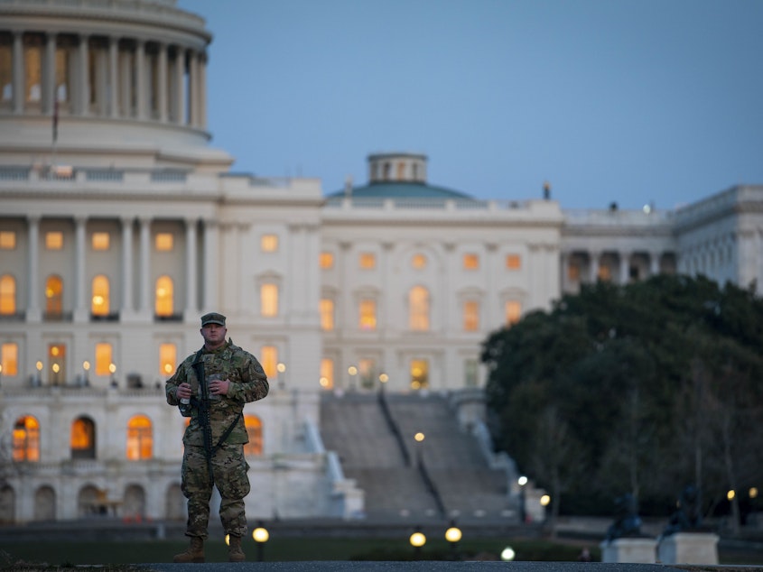 caption: A member of the National Guard patrols outside of the U.S. Capitol on Monday.