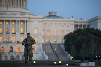 caption: A member of the National Guard patrols outside of the U.S. Capitol on Monday.
