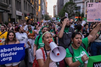 caption: Abortion rights activists march from Washington Square Park to Bryant Park in protest of the overturning of Roe v. Wade by the U.S. Supreme Court. The march was in New York on June 24, 2022.