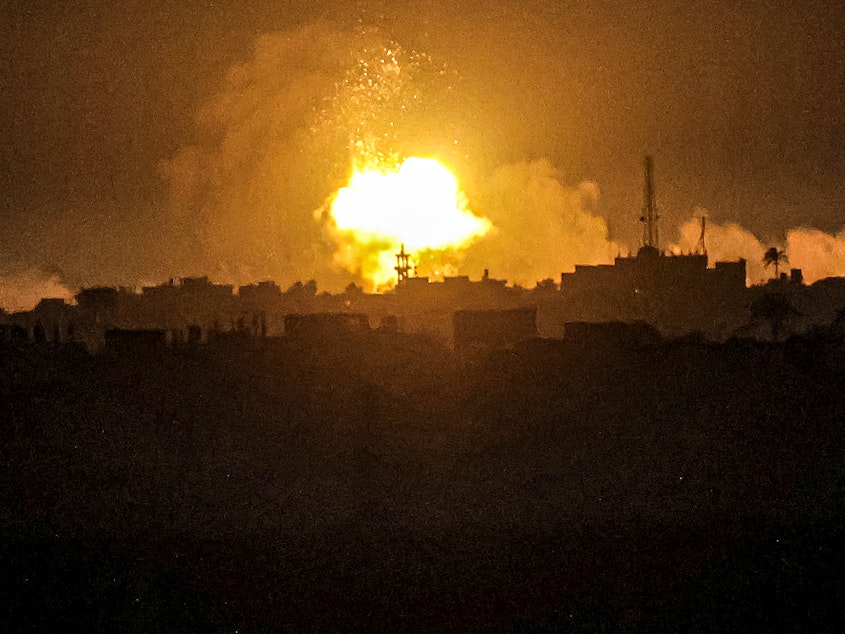 caption: A fireball from an explosion erupts during Israeli bombardment on Khan Younis from Rafah in the southern Gaza Strip early on Wednesday.