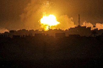 caption: A fireball from an explosion erupts during Israeli bombardment on Khan Younis from Rafah in the southern Gaza Strip early on Wednesday.
