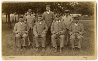 caption:  This historical photo, provided to Oregon Public Broadcasting by Pacific University archivist Eva Guggemos, shows seven boys who came to the Forest Grove Indian Training School from the Spokane tribe in 1880. The Forest Grove school operated for a few years before being relocated to Salem and renamed Chemawa Indian School.