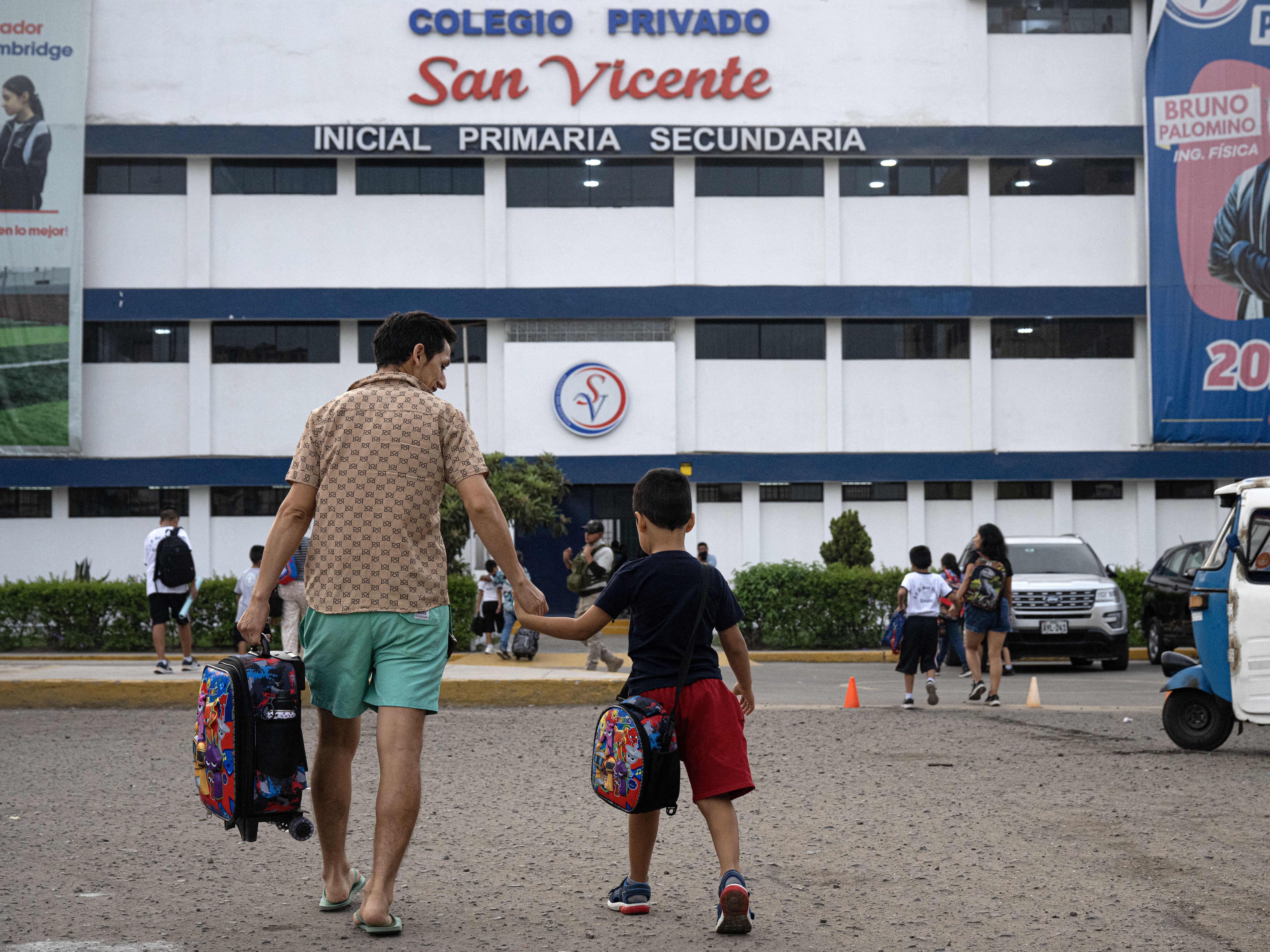 caption: Parents drop off their children at the private San Vicente School in Lima, Peru, which was targeted for extortion, in April.