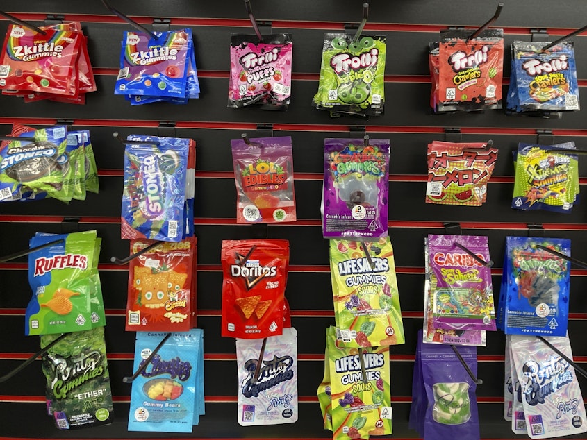 caption: Edible products advertised as containing delta-8 THC offered for sale at a smoke shop in Seattle in 2022. Teens can overdo it with products like these, health officials warn.