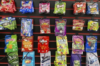 caption: Edible products advertised as containing delta-8 THC offered for sale at a smoke shop in Seattle in 2022. Teens can overdo it with products like these, health officials warn.