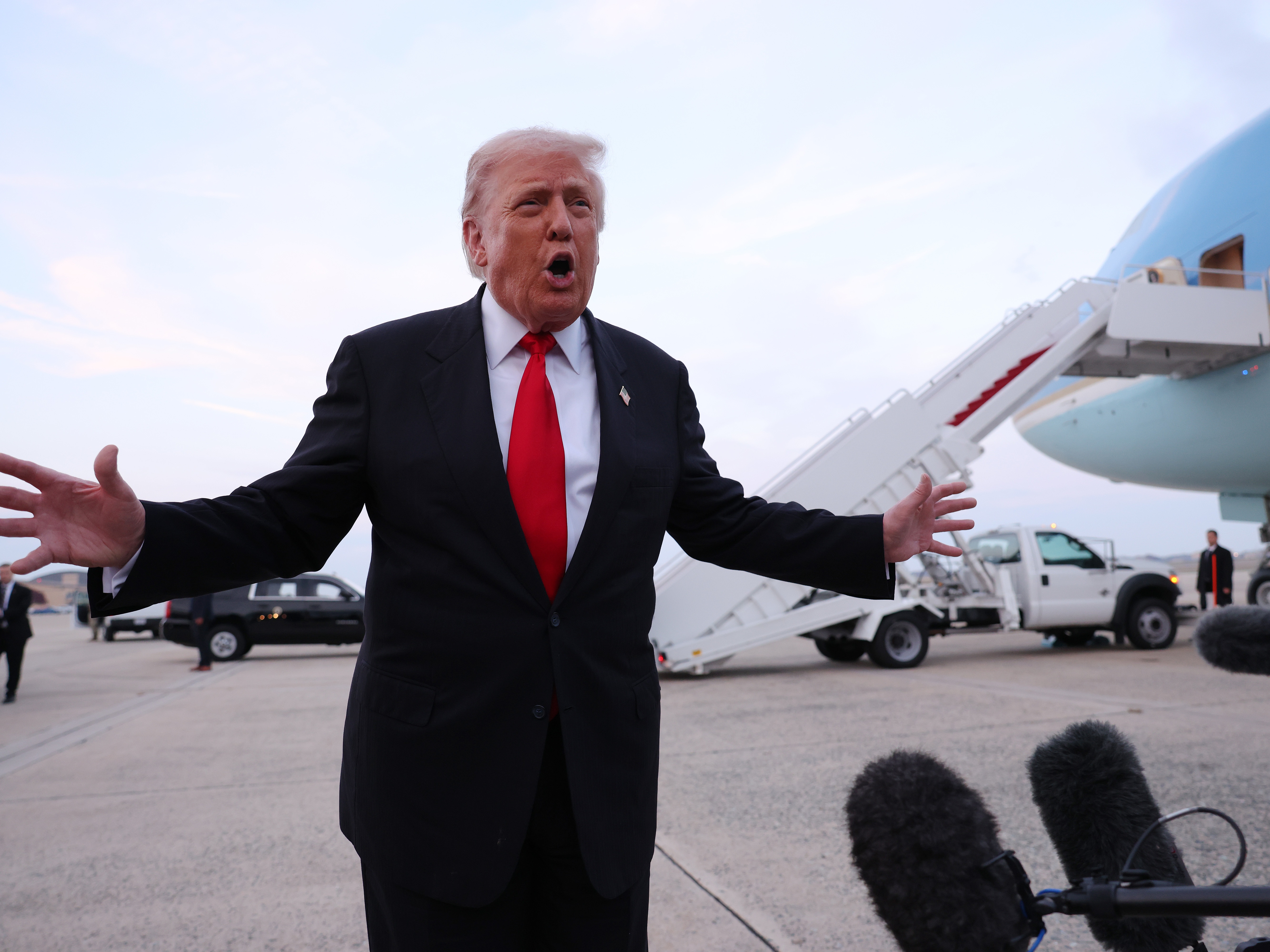 caption: President Trump gives brief remarks to members of the press after exiting Air Force One on Sunday.