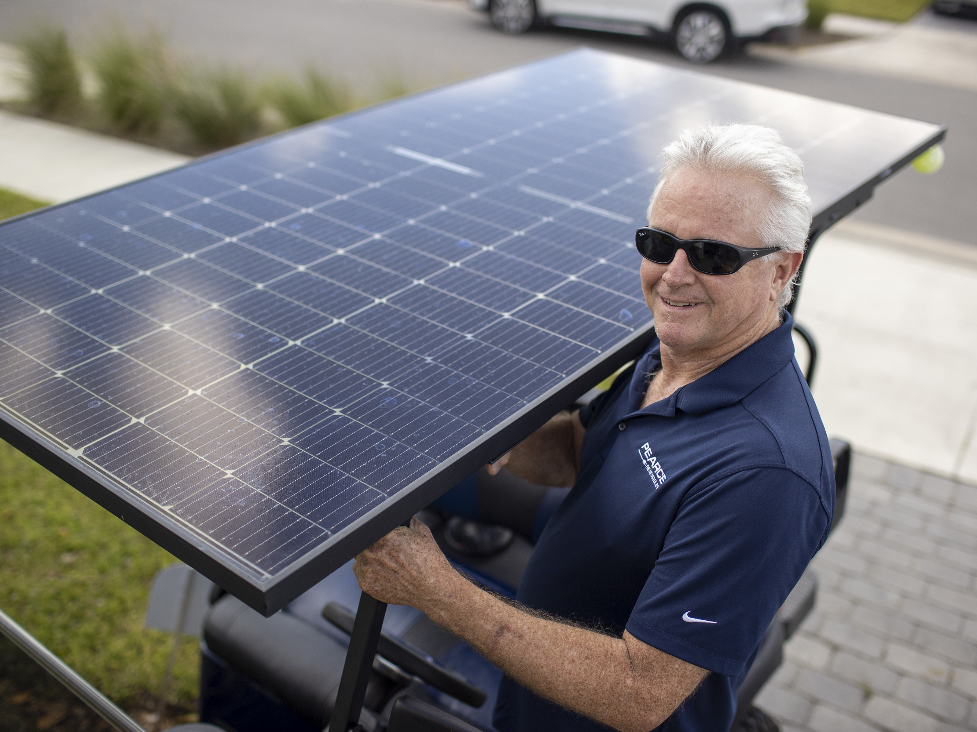 caption: Mark Wilkerson with his solar-powered golf cart. He was one of the first 100 people to move into Babcock Ranch.