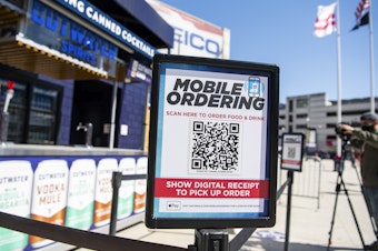 caption: A mobile ordering sign is seen on March 30 at a vending station in Nationals Park, home of the Washington Nationals. The Nats, along with many other teams in baseball, are implementing new safety protocols, including for ordering food, as a new season kicks off on Thursday.