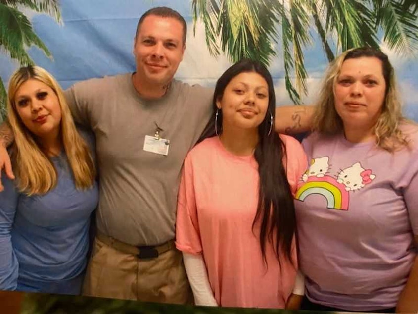 caption: Charles Longshore, pictured center left, poses for a photo with his sister and nieces during a recent visit.