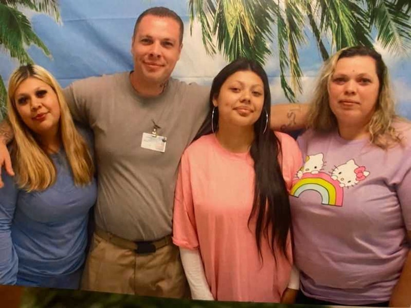 caption:  Charles Longshore, pictured center left, poses for a photo with his sister and nieces during a recent visit. 