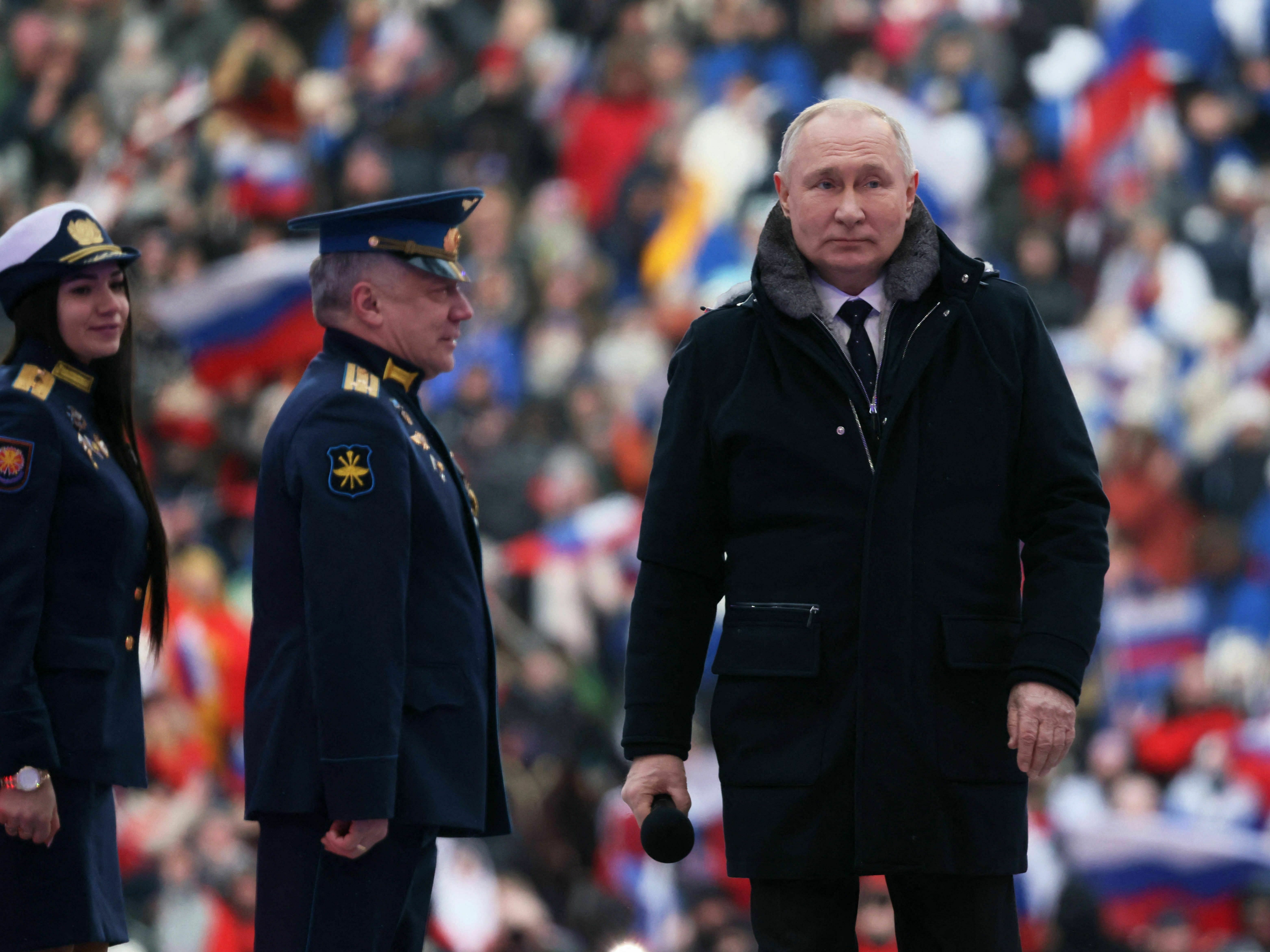 caption: Russian President Vladimir Putin attends a patriotic concert at Luzhniki Stadium in Moscow on Wednesday.