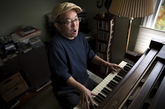 caption: Deems Tsutakawa, the third of George and Ayame Tsutakawa's four children, plays his grand piano on Tuesday, November 28, 2017, at his home in Seattle. 