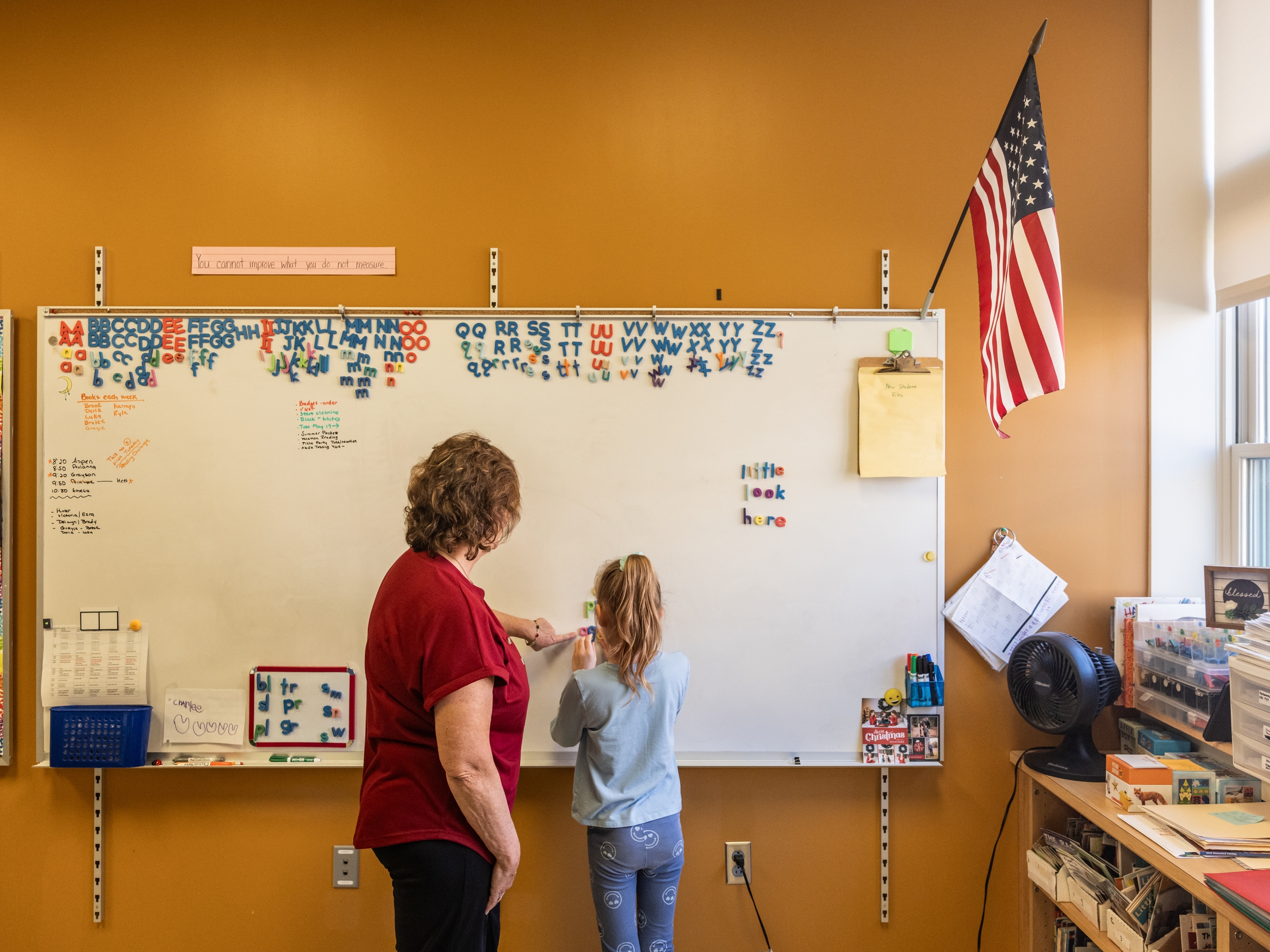 caption: Reading interventionist Roxanne Davis works with a first grader on forming words at Mill Stream Elementary School.
